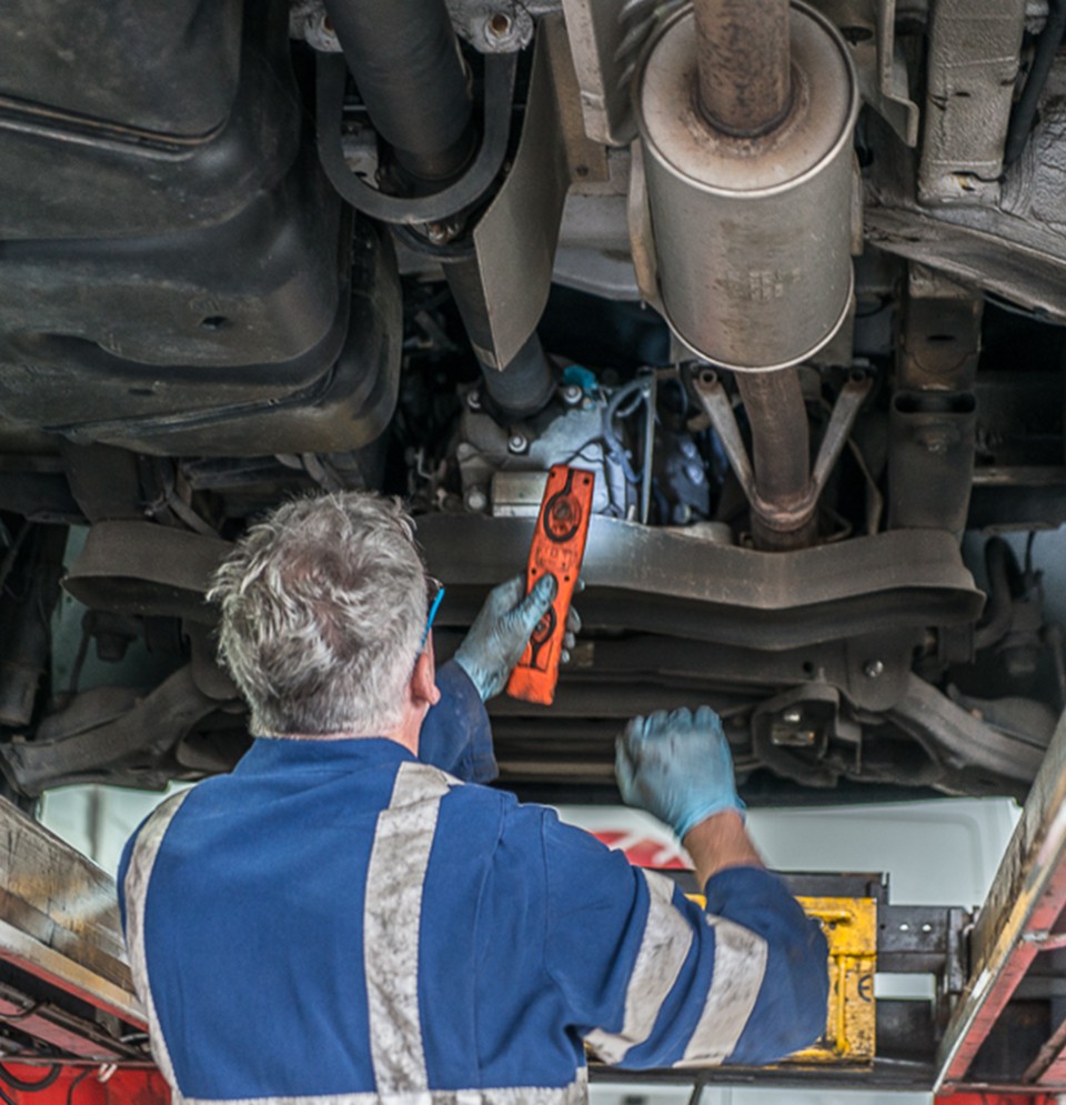 Picture of a mechanic repairing a van